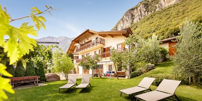 Urlaub auf dem Bauernhof - Eislaufen - Trentino-Südtirol - Unser Haus mit Spiel- und Liegewiese, umgeben von Weinreben und Olivenbäumen. - Lindenhof